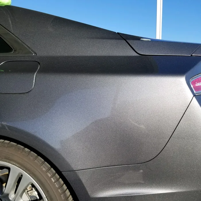Sedan quarter panel after paintless dent repair