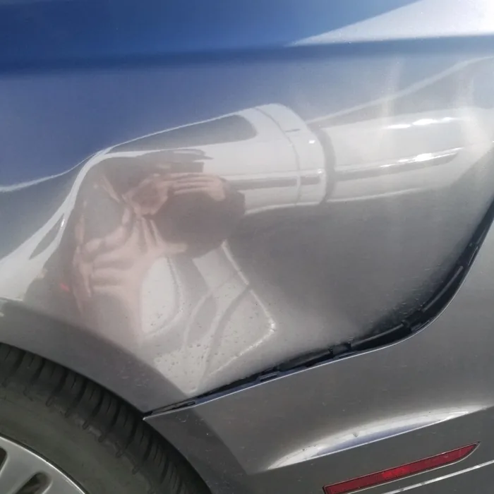 Sedan quarter panel dent before repair