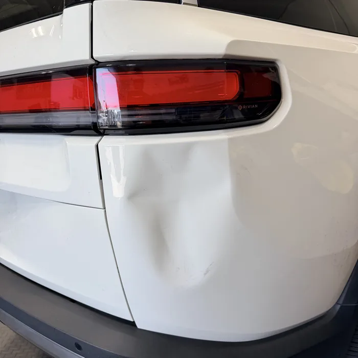 SUV quarter panel dent before repair
